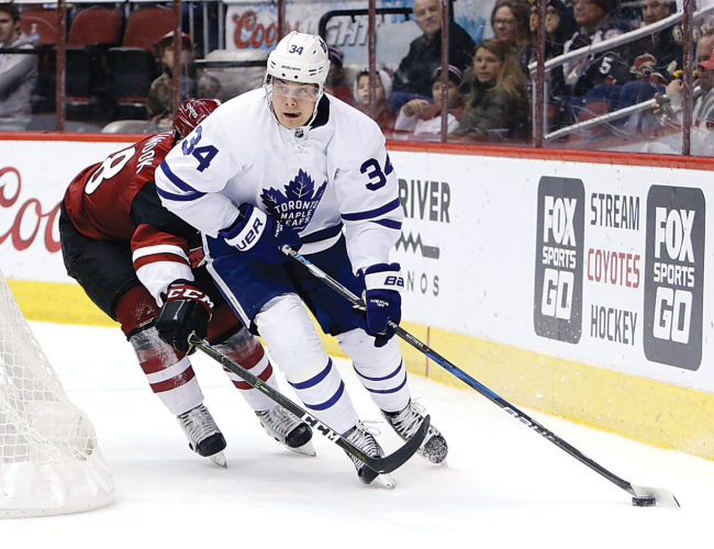 AP Photo Toronto Maple Leafs center Auston Matthews (34) shields Arizona Coyotes center Christian Dvorak from the puck during the first period of an NHL hockey game, Friday in Glendale, Ariz.